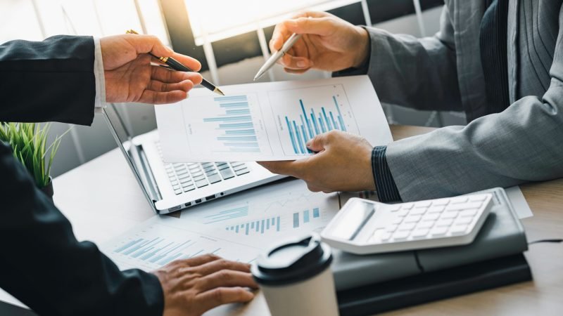 Analyzing results, Businessman accountant or financial expert analyze business report graph and finance chart at the corporate office. Concept of finance economy, banking business, and stock market